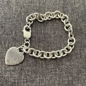 Tiffany link bracelet with heart charm.